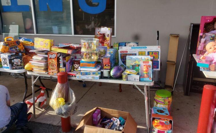 Toys and games sit outside the Kids Feeding Kids Thrift Store as volunteers worked to assemble Christmas baskets for children in need. (COURTESY)