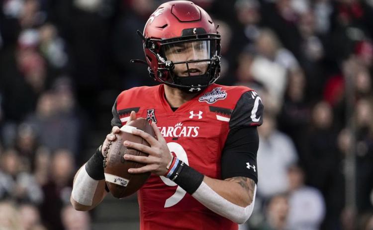 Cincinnati quarterback Desmond Ridder looks to pass from the pocket during the American Athletic Conference championship game against Houston on Dec. 4 in Cincinnati. The fourth-ranked Bearcats (13-0) get their shot in the CFP semifinal Cotton Bowl on Friday against No. 1 defending national champion Alabama. (AP File)