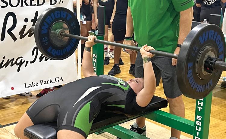 Suwannee’s Emily Gamble bench presses during the Bulldogs’ Power of Christmas invitational. Gamble placed ninth overall in the 169-pound class. (TJ VICKERS/Special to the Reporter)