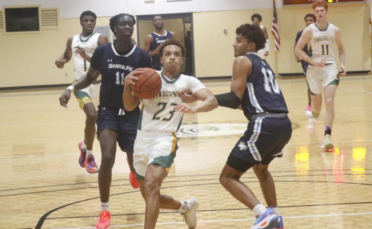 FGC guard Jazan Johnson drives past Santa Fe College guard Nicolas McClain on Tuesday night at the Howard Center. (JORDAN KROEGER/Lake City Reporter)