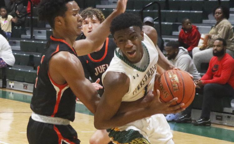 FGC's Jeremiah Barze tries to get around a Johnson U. defender to shoot on Thursday night.  (JORDAN KROEGER/Lake City Reporter)