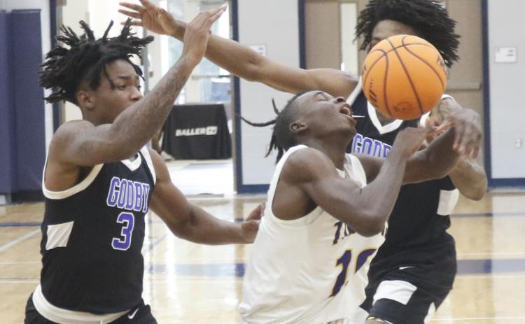 Columbia guard Isaac Broxey has the ball knocked away from him by a Godby defender during the final day of the Hitchcock’s Challenge at Legacy Park on Thursday in Alachua. (JORDAN KROEGER/Lake City Reporter)