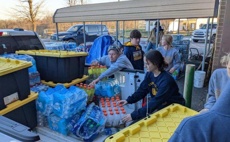 CHS FFA Alumni president Kelly Trimble (center) helps unload supplies with FFA members in Kentucky. (COURTESY)