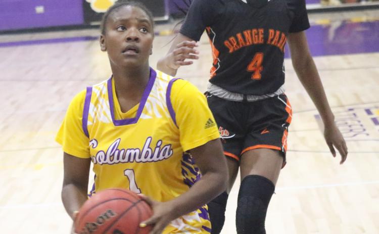 Columbia guard Anzarria Jerkins goes up for a shot as Orange Park guard Eris Lester chases from behind on Thursday night. (JORDAN KROEGER/Lake City Reporter)