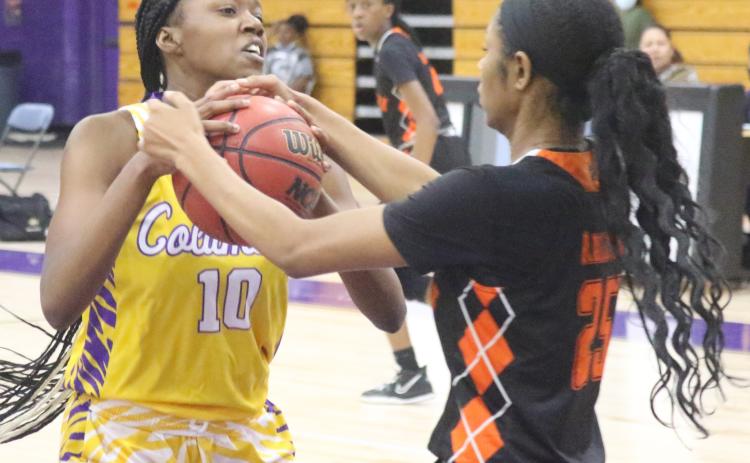Columbia center Keturah Taylor fights for possession of the ball with Orange Park forward Nia Brown on Jan. 13. (JORDAN KROEGER/Lake City Reporter)