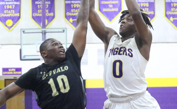 Columbia forward Marcus Peterson shoots over The Villages forward Ja-Quez Oliver on Friday night. (JORDAN KROEGER/Lake City Reporter)