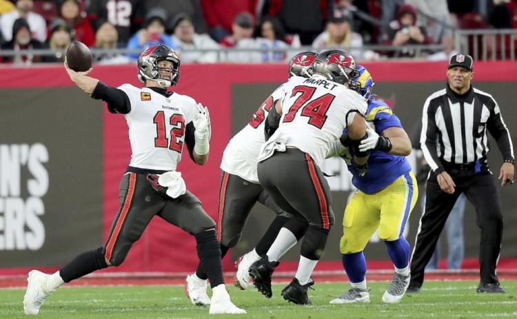 Tampa Bay Buccaneers quarterback Tom Brady (12) passes the ball as Tampa Bay Buccaneers guard Ali Marpet (74) blocks during an NFL divisional playoff game between the Los Angeles Rams and Tampa Bay Buccaneers on Jan. 23 in Tampa. (AP FILE)