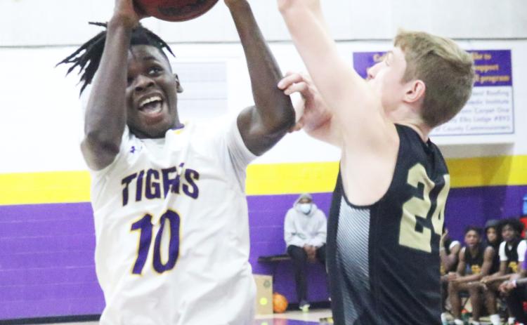 Columbia guard Isaac Broxey rises to shoot as The Villages Charter forward Sam Walters contests on Friday night. (JORDAN KROEGER/Lake City Reporter)