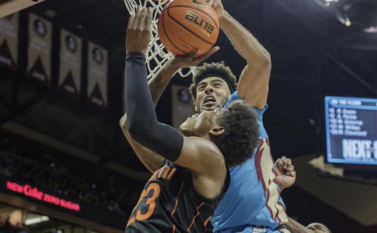 Miami guard Kameron McGusty (23) is blocked by Florida State guard Anthony Polite (2) during Tuesday's game at the Tucker Civic Center in Tallahassee. (ALICIA DEVINE/Tallahassee Democrat via AP)