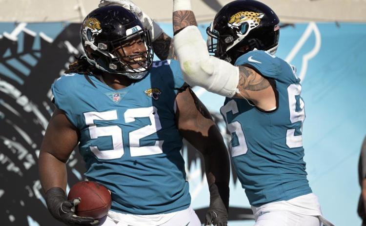 Jacksonville Jaguars defensive tackle DaVon Hamilton (52) celebrates after recovering an Indianapolis Colts fumble with teammate defensive end Adam Gotsis during Sunday's game in Jacksonville. (PHELAN M. EBENHACK/Associated Press)