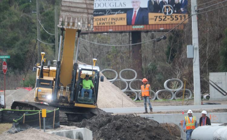 A construction crew works on the drainage system near the future roundabout at Northwest Bascom Norris Drive and U.S. Highway 41. (TONY BRITT/Lake City Reporter)