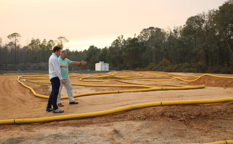 Landen Lewis (left) and Lance McDonald look over the track Thursday afternoon for the Florida RC Championship. (TONY BRITT/Lake City Reporter)