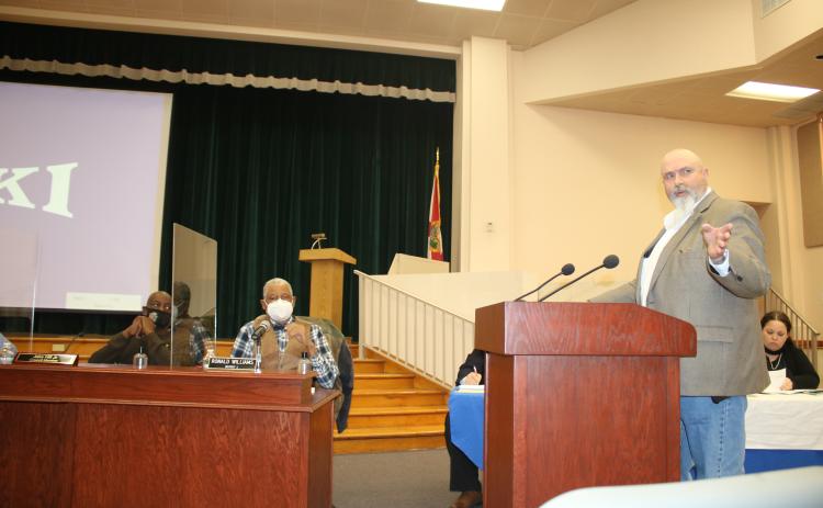 Lake City Utilities Director Paul Dyal (right) points to the crowd during the joint meeting Monday night. (TONY BRITT/Lake City Reporter)