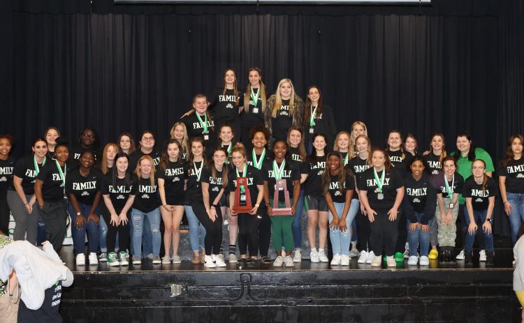Suwannee’s girls weightlifting team poses with the Region 1-1A trophy on Friday night. (PAUL BUCHANAN/Special to the Reporter)