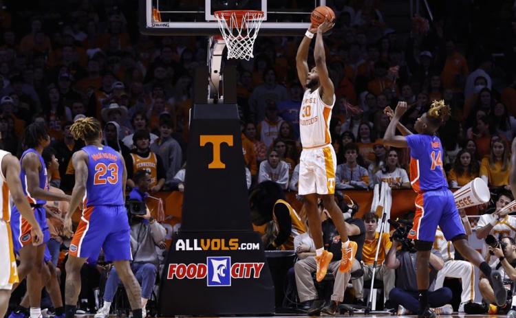 Tennessee guard Josiah-Jordan James (30) goes for a dunk past Florida guard Kowacie Reeves (14) during Wednesday's game in Knoxville, Tenn. Tennessee won 78-71. (WADE PAYNE/Associated Press)