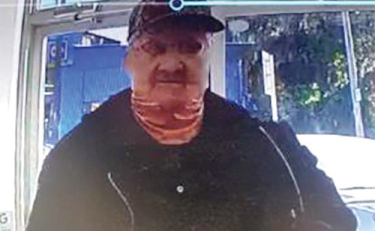 An armed man, wearing a mask, robbed the North Florida Pharmacy’s Fort White location Thursday. (COURTESY)