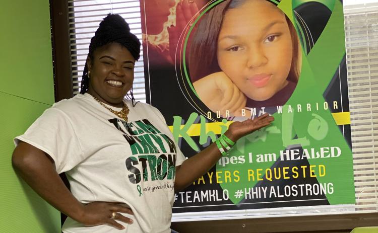 LaKesia Hendon shows off a poster of MiKhiya Hendon in her hospital room at Shands. (COURTESY)