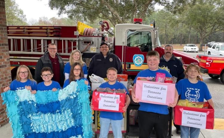 Columbia City Elementary students hold up donations they collected as a gift to veterans at the Lake City VA Medical Center. (COURTESY)