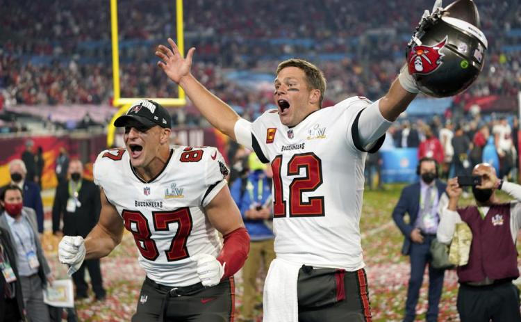 Tampa Bay Buccaneers tight end Rob Gronkowski, left, and quarterback Tom Brady (12) celebrate after winning Super Bowl 55 against the Kansas City Chiefs on Feb. 7, 2021 in Tampa. (AP FILE)