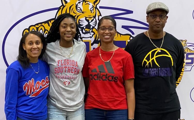 Columbia guard Na’Haviya Paxton (center left) signed her letter of intent to play at Florida Southern on Saturday. She is pictured with Columbia assistant coach Erica Mayo (left), Columbia assistant coach Keisha Kimble (center right) and Columbia head coach Anthony Perry. (COURTESY)
