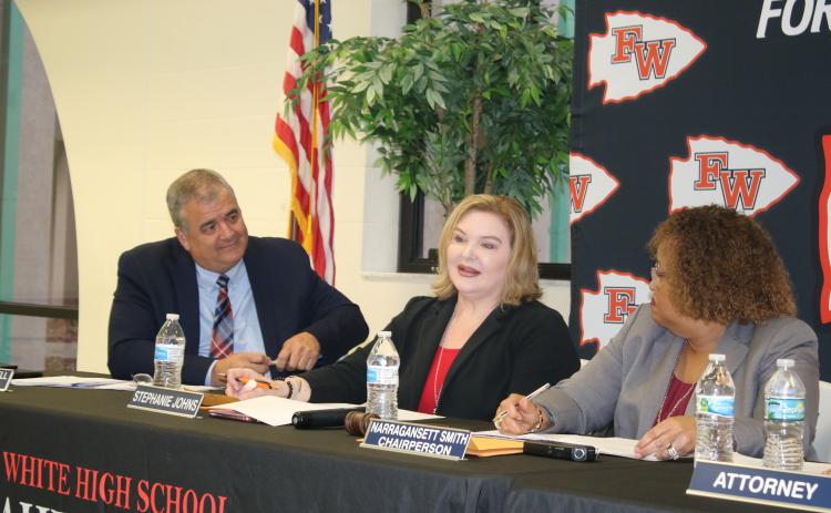 Stephanie Johns (middle) speaks as Superintendent Lex Carswell and Chairperson Narragansett Smith watch during Tuesday’s school board meeting. (TONY BRITT/Lake City Reporter)