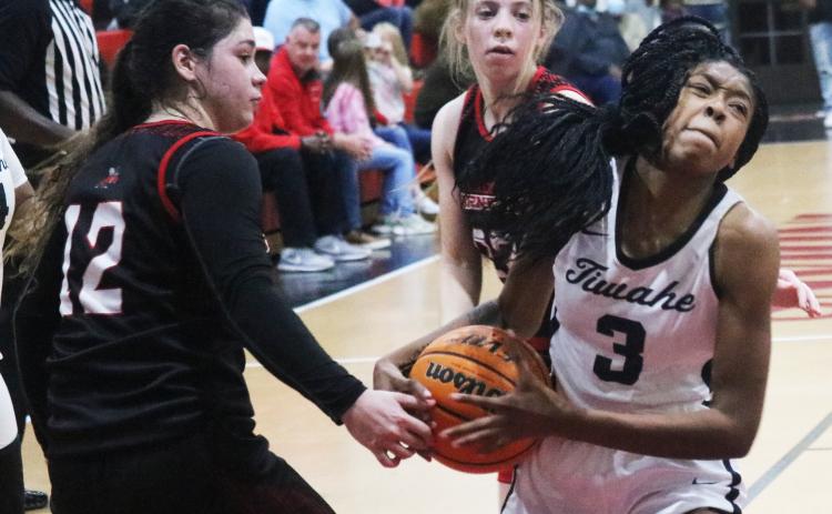 Fort White guard Jacovya Major tries to hold onto possession of the ball as she drives past Lafayette’s Kayla Castillo (23) and Emily Lyons (12) during Thursday night’s Region 3-1A semifinal. (JORDAN KROEGER/Lake City Reporter)