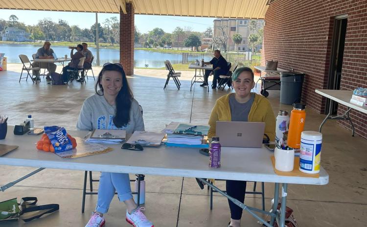 Volunteers sit at a makeshift desk at Wilson Park during a Florida drivers license restoration event. (COURTESY)