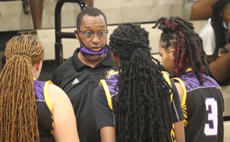 Columbia head coach Anthony Perry talks to guard Na'Haviya Paxton (middle) during a timeout of the District 3-6A championship game against Gainesville on Friday. (JORDAN KROEGER/Lake City Reporter)