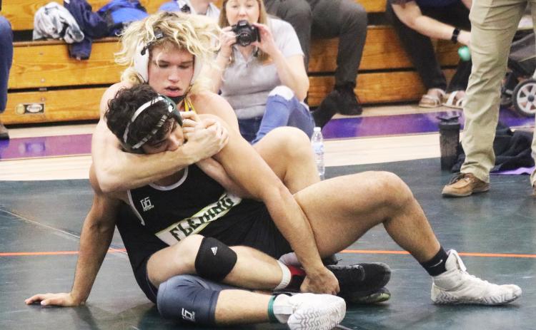 Columbia’s Joseph Rice wrestles with Fleming Island’s Joshua Sandoval during Wednesday’s District 2-2A title match in the 170 class. (JORDAN KROEGER/Lake City Reporter)