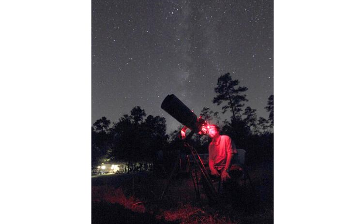 Late astrophotographer Steve Speck sets up his camera and telescope in the night hours. (COURTESY)