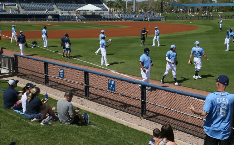 The Tampa Bay Rays are shown warming up before a game in February 2021 in Port Charlotte. (LUIS SANTANA/TNS)