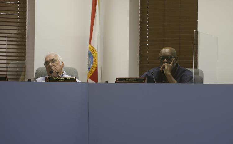 Mayor Stephen Witt (left) and Lake City Councilman Jake Hill listen during Wednesday’s interviews. (JAMIE WACHTER/Lake City Reporter)