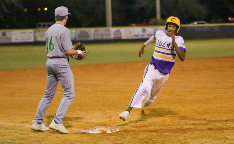 Columbia first baseman Brayden Thomas turns off third base and heads home to score a run against Suwannee on Tuesday night. (BRENT KUYKENDALL/Lake City Reporter)