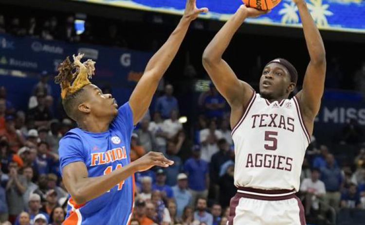 Texas A&M guard Hassan Diarra makes the game-winning shot over Florida guard Kowacie Reeves during overtime of Thursday's game at the Southeastern Conference tournament in Tampa. (CHRIS O'MEARA/Associated Press)