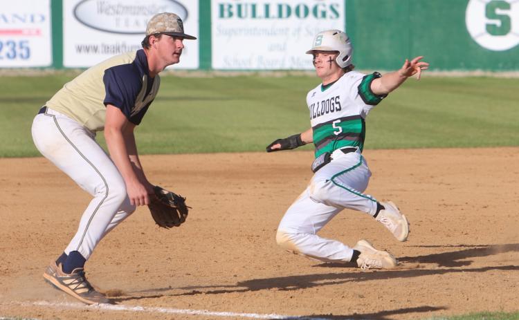 Suwannee’s Josh Fernald slides into third base ahead of a throw against Holmes County on Monday. (PAUL BUCHANAN/Special to the Reporter)