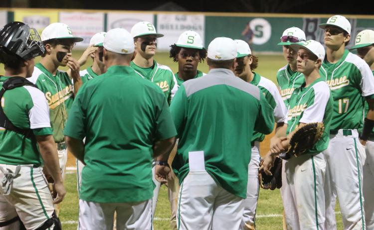 Suwannee’s baseball team huddles up postgame to listen to head coach Justin Bruce after losing to West Nassau 14-6 on Tuesday. (PAUL BUCHANAN/Special to the Reporter)