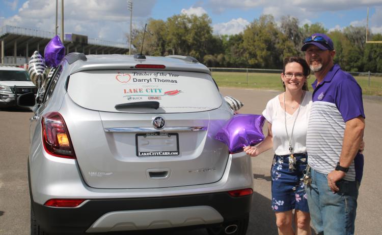 Columbia High welding teacher Darryl Thomas and his wife, Jan, stand with their brand new Buick Encore, a prize Thomas won for being named the Columbia County School District’s Teacher of the Year. (TONY BRITT/Lake City Reporter)