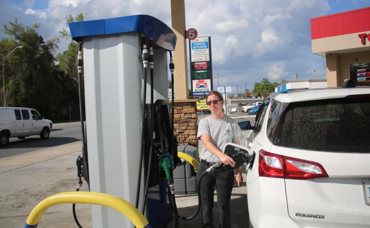 Kimberly Rice pumps $30 worth of gas into her vehicle Tuesday afternoon where she paid $4.25 per gallon of unleaded at the Stop N Go on Main Boulevard. (TONY BRITT/Lake City Reporter)