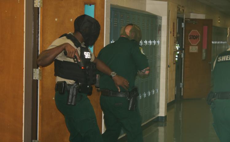 A pair of Columbia County Sheriffs make their way down a Lake City Middle School hallway Friday during training exercises. Law enforcement officers received the training to combat active shooters in schools. (TONY BRITT/Lake City Reporter)