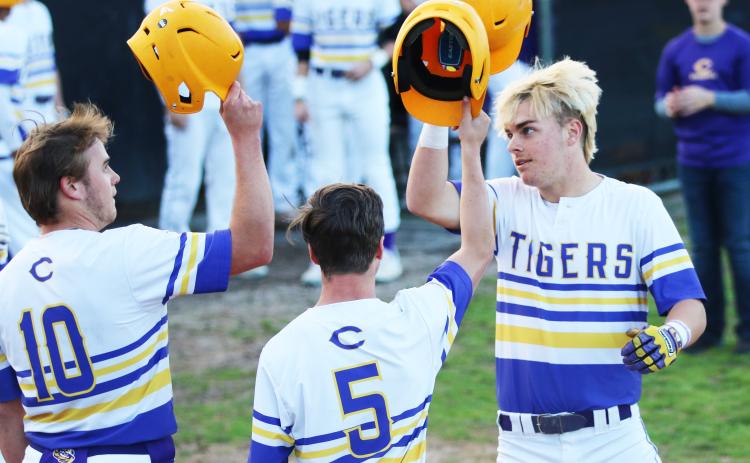 Columbia third baseman Hayden Gustavson (right) celebrates at home plate with first baseman Brent Howard (10) and outfielder Matthew Dumas (5) after hitting a 3-run home run against Valwood in the first inning Monday night. (JORDAN KROEGER/Lake City Reporter)