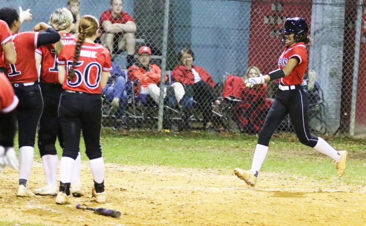 Fort White outfielder Morgan Kelly is all smiles as she heads toward home plate after hitting a home run against Lafayette on Thursday night. (MORGAN MCMULLEN/Lake City Reporter)