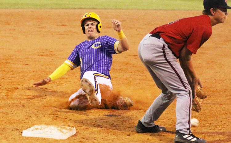 Columbia third baseman Hayden Gustavson slides into third base safely against Baker County on Tuesday night. (MORGAN MCMULLEN/Lake City Reporter)
