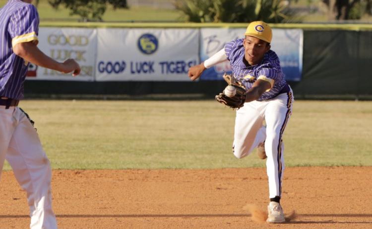Columbia second baseman Brayden Thomas just misses a ball through the infield during Friday night’s game against Buchholz. (BRENT KUYKENDALL/Lake City Reporter)