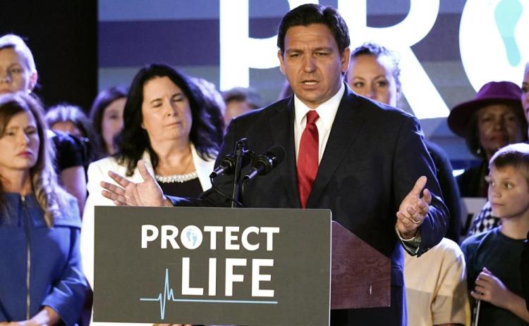 Florida Gov. Ron DeSantis speaks to supporters before signing a 15-week abortion ban into law Thursday in Kissimmee. The move comes amid a growing conservative push to restrict abortion ahead of a U.S. Supreme Court decision that could limit access to the procedure nationwide. (JOHN RAOUX/Associated Press)