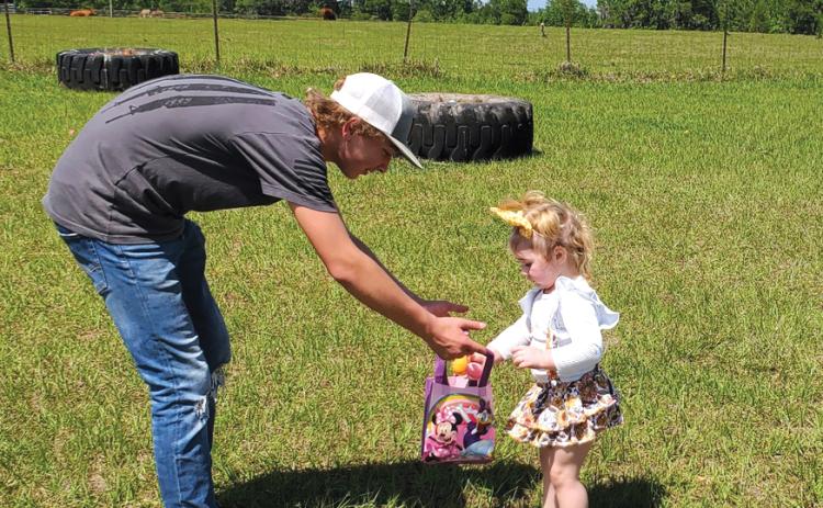 Chapter member Lucky Lloyd helps his niece, Leighton Todd, as she finds Easter eggs on April 15. (COURTESY)