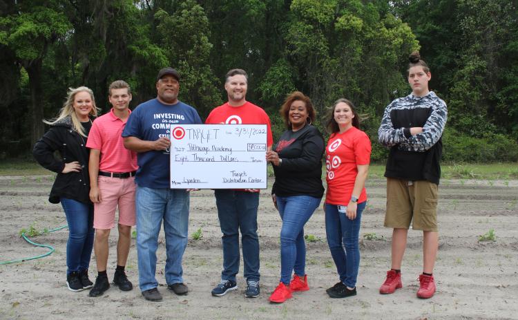 Bobby Brewin (center) with the Lake City Target Distribution Center presents an $8,000 check to Adee Farmer for the Pathways Academy garden. Also present were Dianna Swisher (from left), Brandon Ray, Pathways Principal Makeba Murphy, Nicole Robertson and Joseph Lee Pendleton. (TONY BRITT/Lake City Reporter)