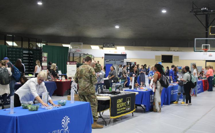 Florida Gateway College students talk to representatives area employers and colleges during the college’s Job Fair, Transfer Day and Spring Fling event on Wednesday at the Howard Conference Center. (TONY BRITT/Lake City Reporter)