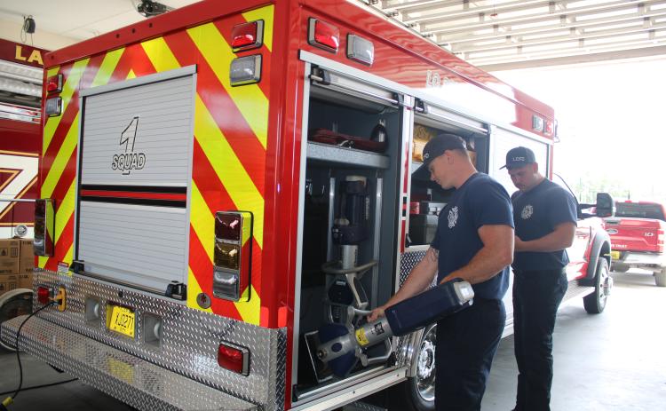 Hunter Anderson (from left) and Adam Lockwood, Lake City Fire Department firefighters, inventory extrication equipment that is carried in the department’s new Quick Response Truck on Wednesday afternoon. (TONY BRITT/Lake City Reporter)