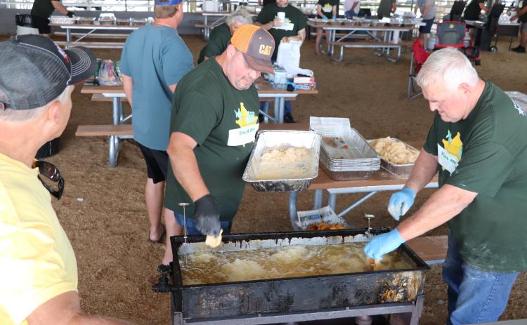 COURTESY A pair of volunteers work on frying up fish during the 11th annual Fins and Pins fundraiser on Saturday. Fins and Pins raised roughly $40,000 during the fish fry and bowling outing. (COURTESY)