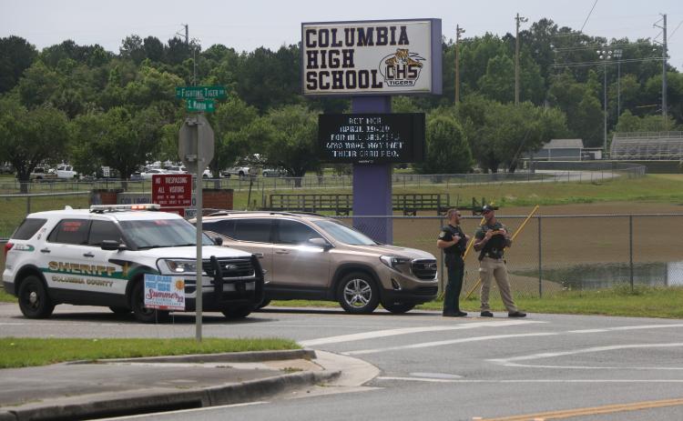 Law enforcement blocks the entrance to Columbia High School on Monday morning after a bomb threat was made against the school. A sweep of the building turned up nothing suspicious. (MORGAN MCMULLEN/Lake City Reporter)